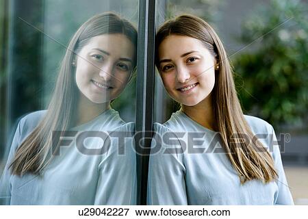 Woman and her mirror reflection on glass wall View Large Photo Image Stock Photo - Woman and her mirror reflection on glass wall. Fotosearch