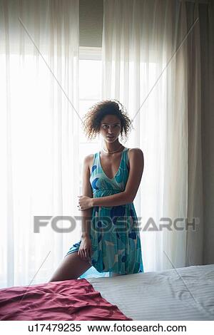 Woman by bedside, soft voile panel in background View Large Photo Image Stock Photography - Woman by bedside, soft voile panel in background. Fotosearch