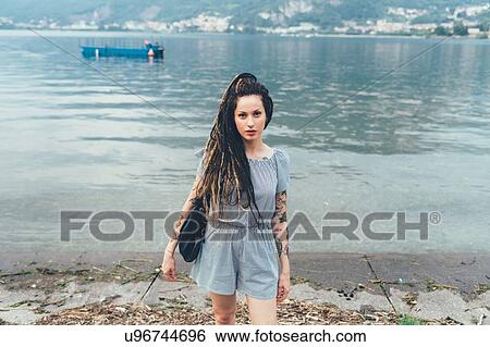 Stock Photograph - Woman by lakeside, Como, Lombardia, Italy. Fotosearch