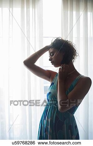 Woman by soft voile panel View Large Photo Image Stock Photograph - Woman by soft voile panel. Fotosearch
