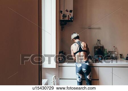 Woman cleaning up in kitchen View Large Photo Image Stock Photo - Woman cleaning up in kitchen. Fotosearch