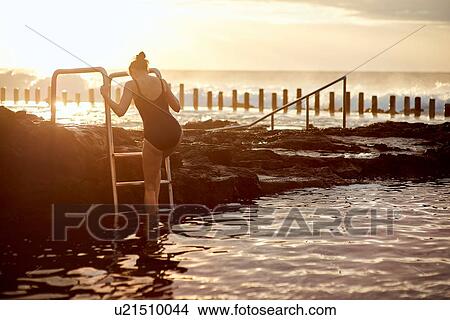 Woman climbing up coastal pool ladder, Las Palmas, Gran Canaria, Canary Islands, Spain View Large Photo Image Picture - Woman climbing up coastal pool ladder, Las Palmas, Gran Canaria, Canary Islands, Spain. Fotosearch