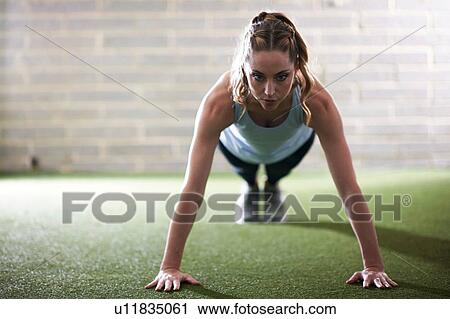 Woman doing plank in gym View Large Photo Image Stock Image - Woman doing plank in gym. Fotosearch