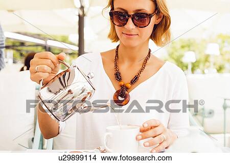 Woman having tea on terrace View Large Photo Image Picture - Woman having tea on terrace. Fotosearch
