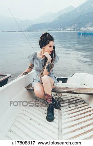 Stock Photo - Woman in boat on lake, Como, Lombardia, Italy. Fotosearch