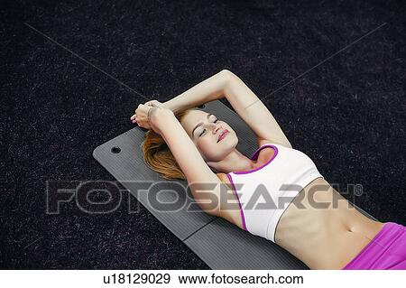Woman in gym doing sit ups View Large Photo Image Stock Photo - Woman in gym doing sit ups. Fotosearch