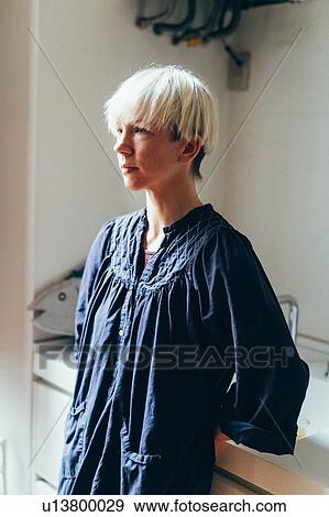 Stock Photo - Woman in kitchen. Fotosearch