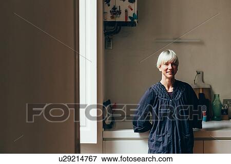 Stock Photo - Woman in kitchen. Fotosearch