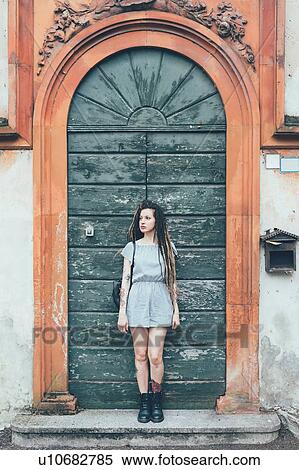 Woman leaning against arched door View Large Photo Image Stock Photography - Woman leaning against arched door. Fotosearch