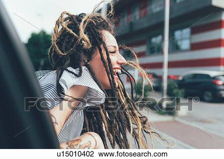 Woman leaning out of car window View Large Photo Image Stock Image - Woman leaning out of car window. Fotosearch