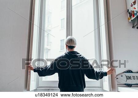 Woman looking out of window View Large Photo Image Picture - Woman looking out of window. Fotosearch