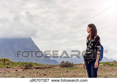 Woman looking out toward low cloud over mountains, Las Palmas, Gran Canaria, Canary Islands, Spain View Large Photo Image Stock Photo - Woman looking out toward low cloud over mountains, Las Palmas, Gran Canaria, Canary Islands, Spain. Fotosearch