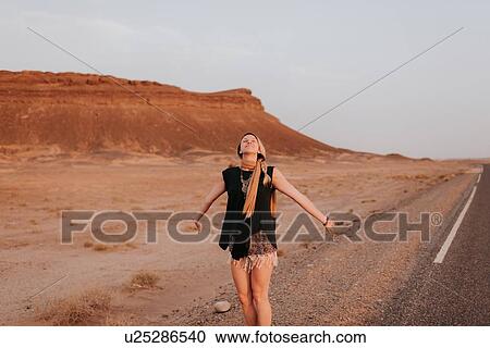Woman on road in desert, Douba, Morocco View Large Photo Image Stock Image - Woman on road in desert, Douba, Morocco. Fotosearch