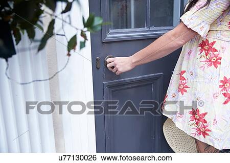 Woman opening door View Large Photo Image Stock Photograph - Woman opening door. Fotosearch