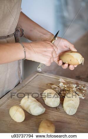 Woman peeling potatoes for gnocchi View Large Photo Image Picture - Woman peeling potatoes for gnocchi. Fotosearch