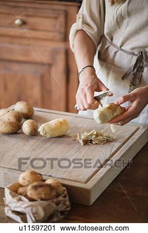Woman peeling potatoes for gnocchi View Large Photo Image Stock Image - Woman peeling potatoes for gnocchi. Fotosearch