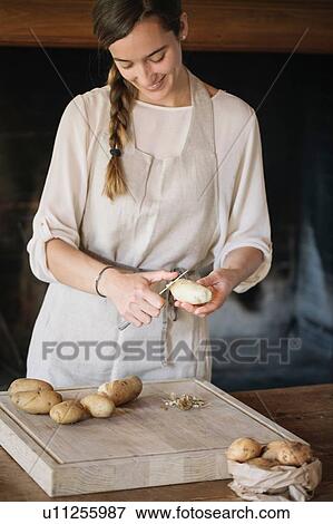 Woman peeling potatoes for gnocchi View Large Photo Image Stock Photo - Woman peeling potatoes for gnocchi. Fotosearch