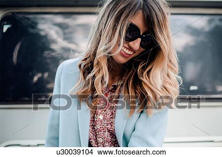Picture - Woman posing near trailer. Fotosearch