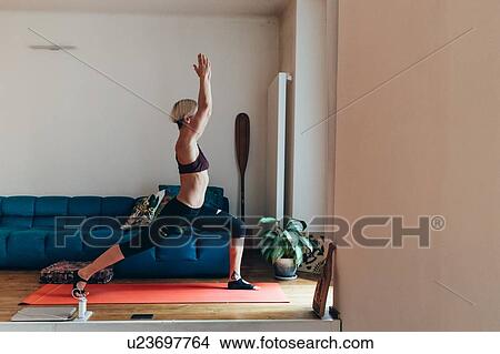 Woman practising yoga at home View Large Photo Image Picture - Woman practising yoga at home. Fotosearch