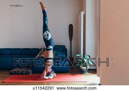 Woman practising yoga at home View Large Photo Image Stock Image - Woman practising yoga at home. Fotosearch