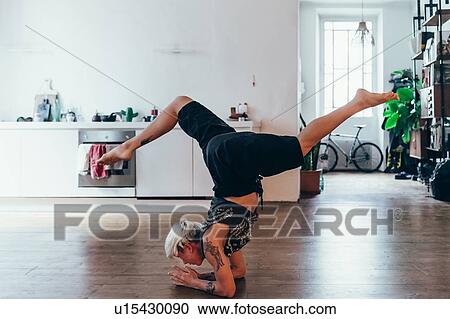Woman practising yoga at home View Large Photo Image Stock Image - Woman practising yoga at home. Fotosearch