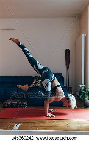 Woman practising yoga at home View Large Photo Image Stock Image - Woman practising yoga at home. Fotosearch