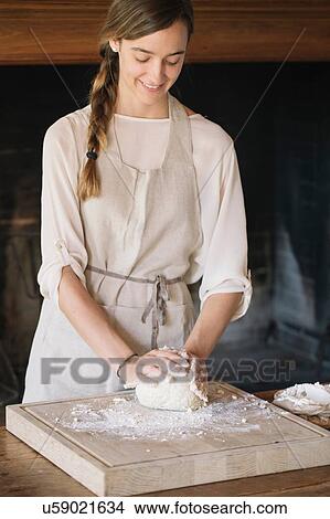 Picture - Woman preparing dough for gnocchi. Fotosearch