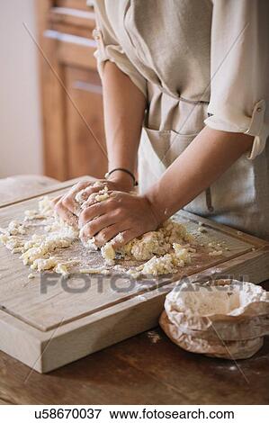 Stock Photo - Woman preparing dough for gnocchi. Fotosearch