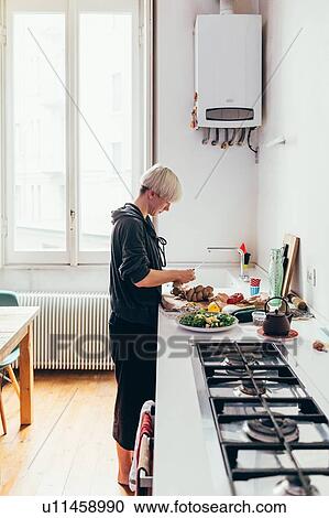 Woman preparing food in kitchen View Large Photo Image Stock Image - Woman preparing food in kitchen. Fotosearch