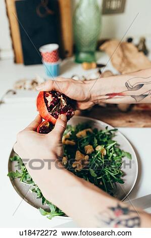 Stock Image - Woman preparing food in kitchen. Fotosearch