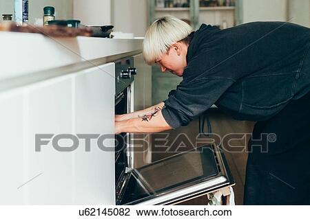 Woman preparing food in kitchen View Large Photo Image Stock Image - Woman preparing food in kitchen. Fotosearch