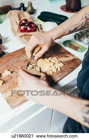 Stock Photo - Woman preparing food in kitchen. Fotosearch