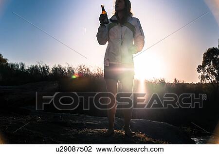 Stock Image - Woman relaxing in camp area, Bishop, California, USA. Fotosearch