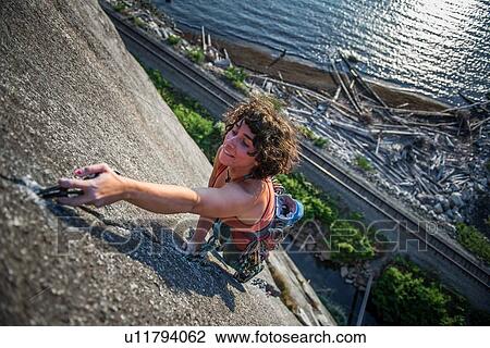 Stock Image - Woman rock climbing, Malamute, Squamish, Canada. Fotosearch