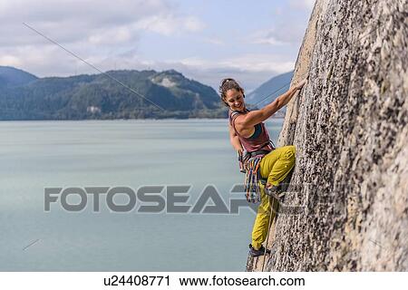 Stock Image - Woman rock climbing, Squamish, Canada. Fotosearch