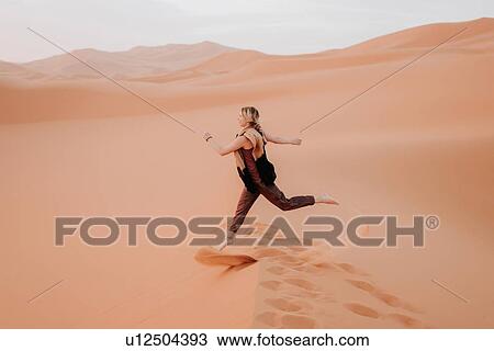 Woman running in desert, Douba, Morocco View Large Photo Image Stock Image - Woman running in desert, Douba, Morocco. Fotosearch