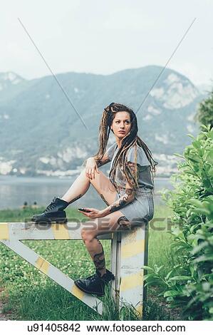 Woman sitting on wooden gate View Large Photo Image Stock Image - Woman sitting on wooden gate. Fotosearch