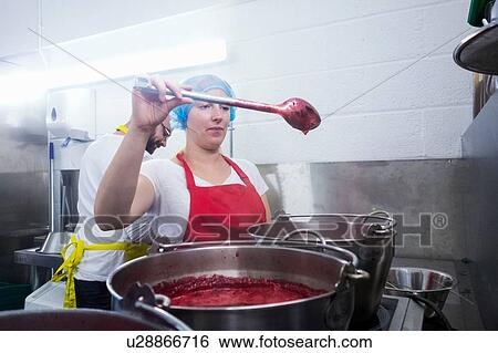 Woman stirring jam in large saucepan on industrial kitchen hob View Large Photo Image Stock Photograph - Woman stirring jam in large saucepan on industrial kitchen hob. Fotosearch