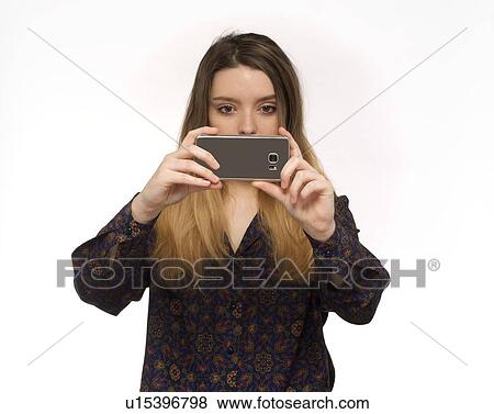 Woman taking photo with smartphone View Large Photo Image Stock Photo - Woman taking photo with smartphone. Fotosearch