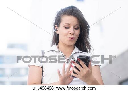 Woman texting on smartphone View Large Photo Image Stock Photo - Woman texting on smartphone. Fotosearch