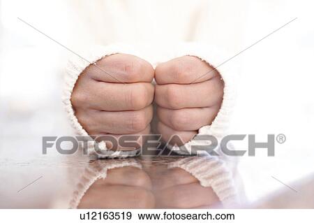 Stock Photo - Woman with hands close together. Fotosearch