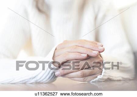 Woman with one hand on top of the other View Large Photo Image Stock Photo - Woman with one hand on top of the other. Fotosearch