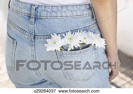 Woman with white flowers in back pocket View Large Photo Image Stock Photo - Woman with white flowers in back pocket. Fotosearch