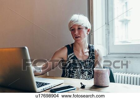 Picture - Woman working at home. Fotosearch