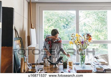 Woman working in her studio View Large Photo Image Stock Photo - Woman working in her studio. Fotosearch