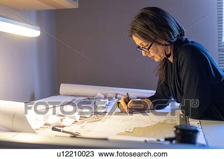 Stock Image - Woman working in home office. Fotosearch