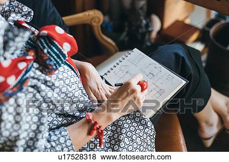 Woman working on designs in her studio View Large Photo Image Stock Photo - Woman working on designs in her studio. Fotosearch