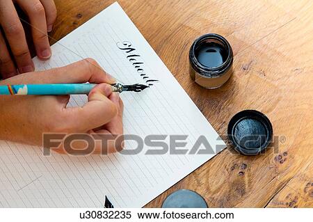 Stock Photography - Woman writing with calligraphy pen. Fotosearch