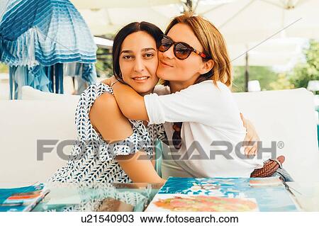 Stock Image - Women relaxing on terrace. Fotosearch