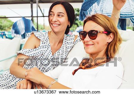 Women relaxing on terrace View Large Photo Image Stock Photo - Women relaxing on terrace. Fotosearch